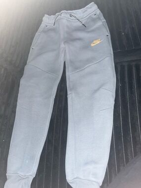 Nike Kids Gray Tech Sweatpants with Orange Swoosh